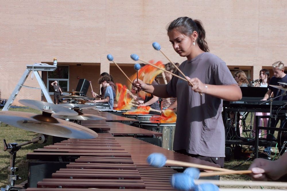 Enka High Marching Band students play xylophone during a practice.