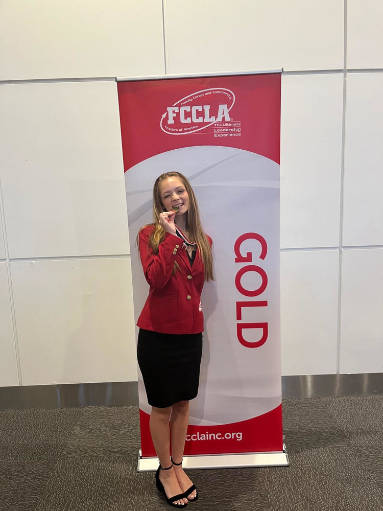 Ada Anderson standing with her gold medal at the FCCLA conference in Denver, Colorado