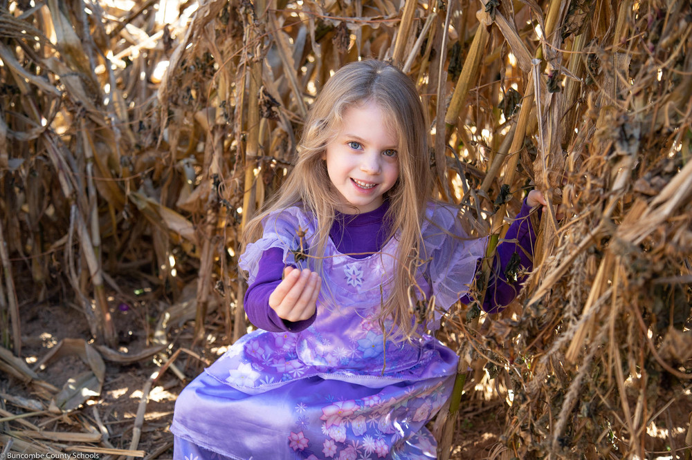 Student posing in the corn maze at Eliada Home