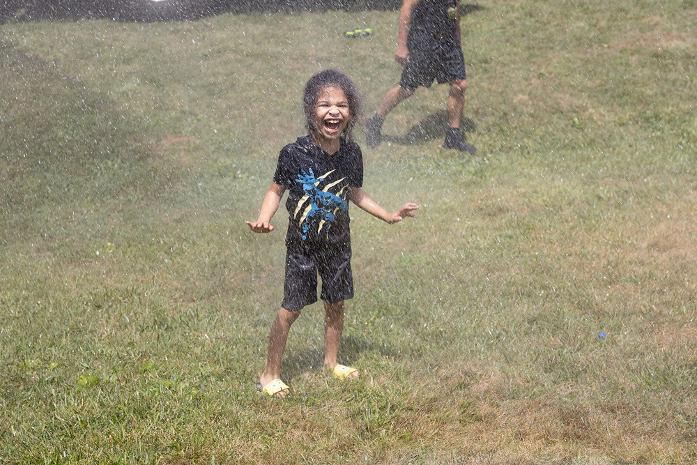 Child playing in a stream of water