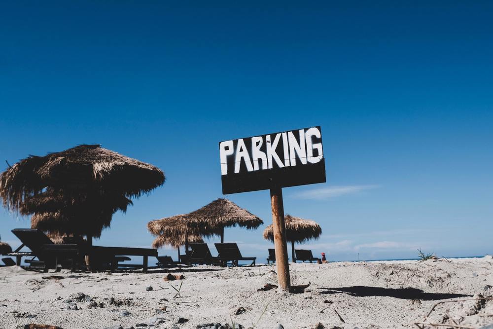 Picture of a parking sign on a beach.