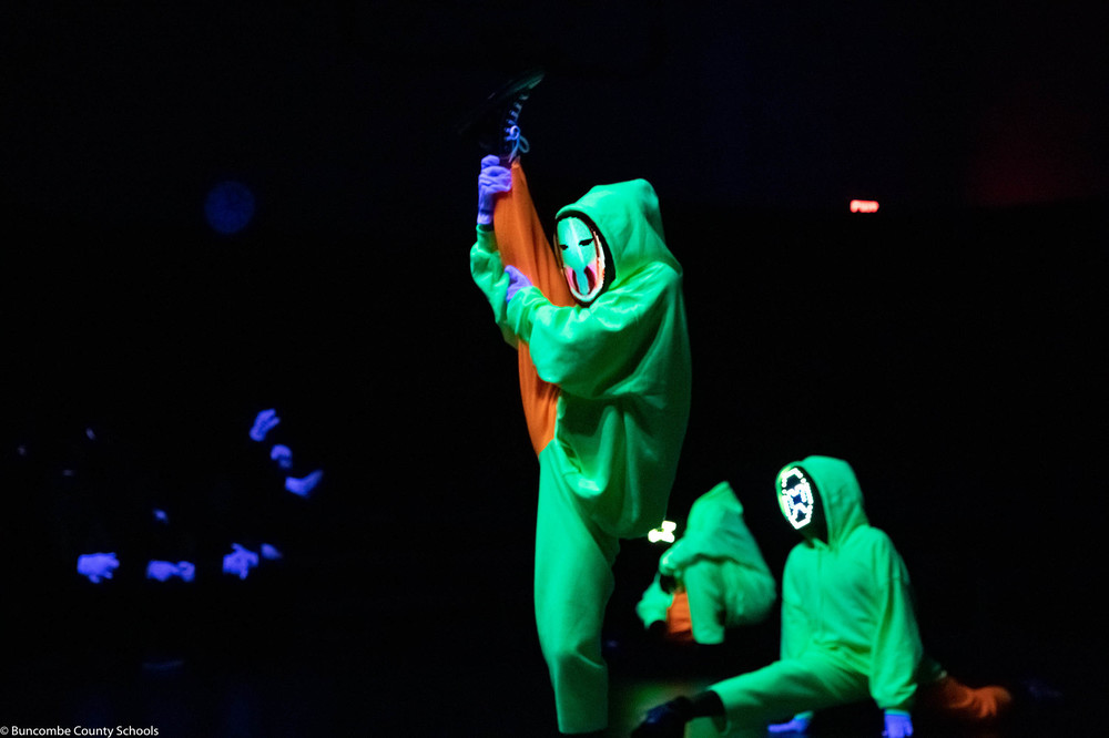 Students performing a routine for the black light show. 