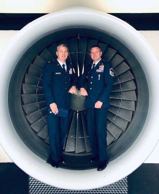 Master Sargent Draper in front of an engine jet