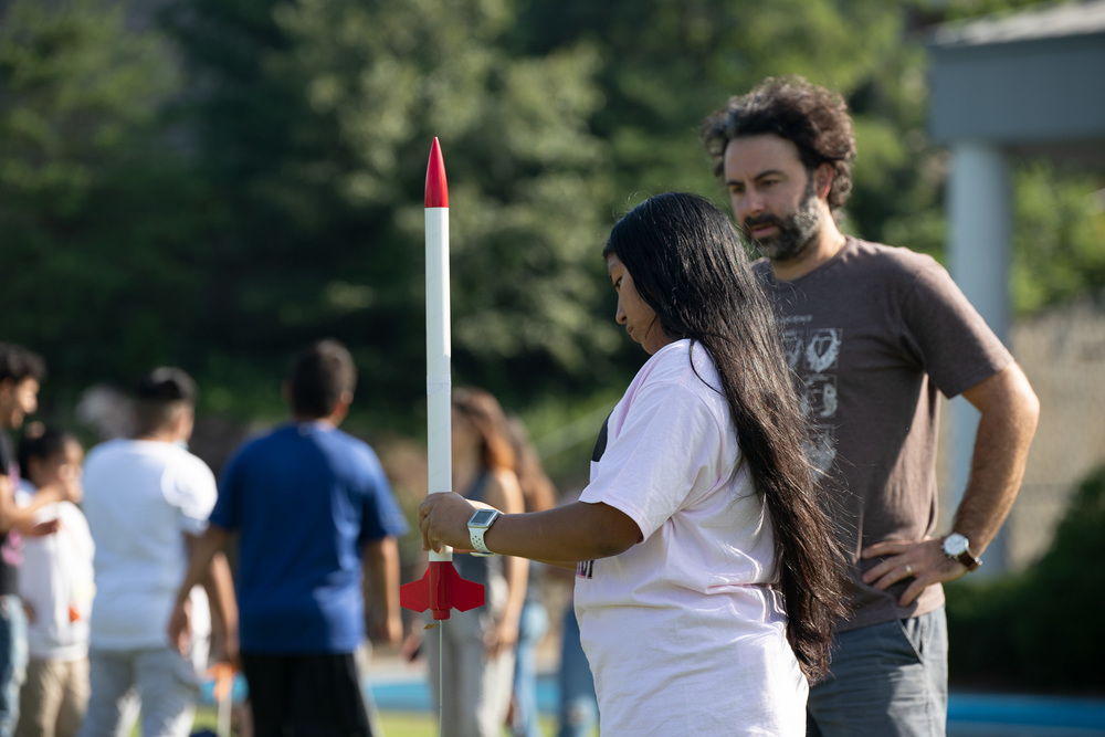 Student in the Migrant Education Program preparing to launch her rocket.