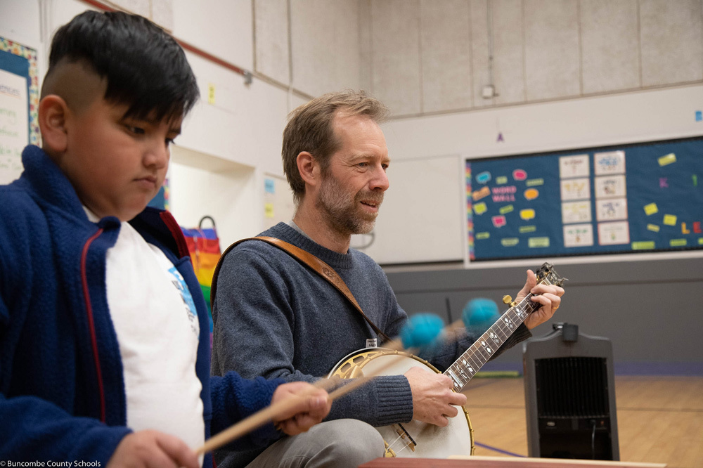 Graham Sharp, right, plays banjo while a student plays xylophone.