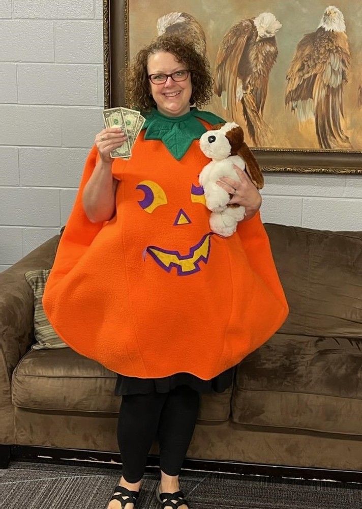 Person holding money and stuffed animal