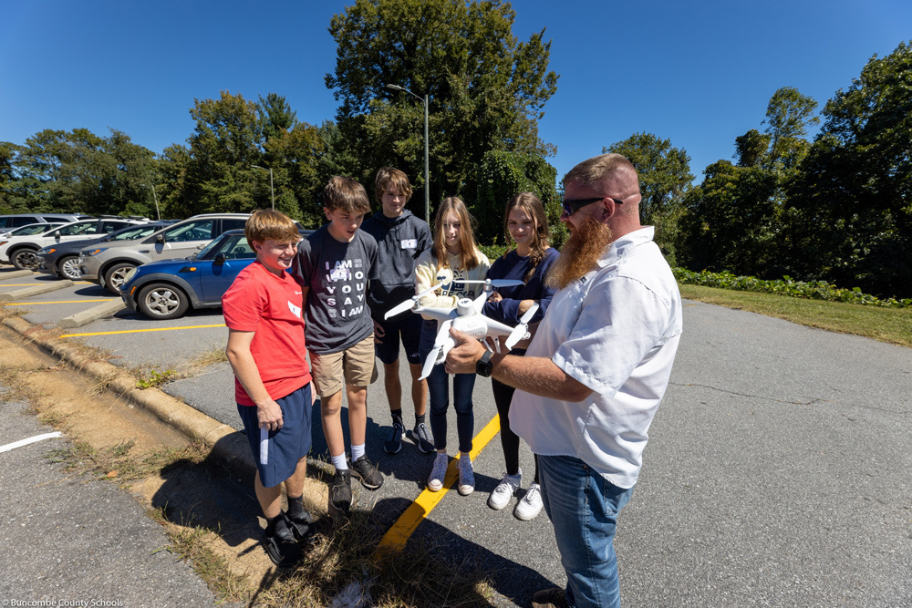 An operator with Ed Holmes and Associates shows a drone to NDA students.