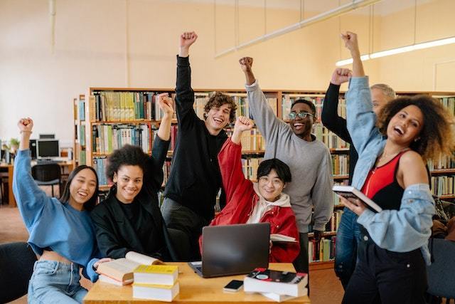 Students celebrating in a library