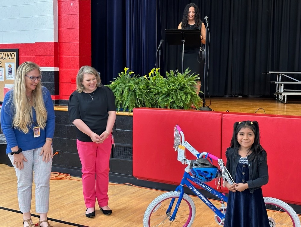 Student standing with her new bike.