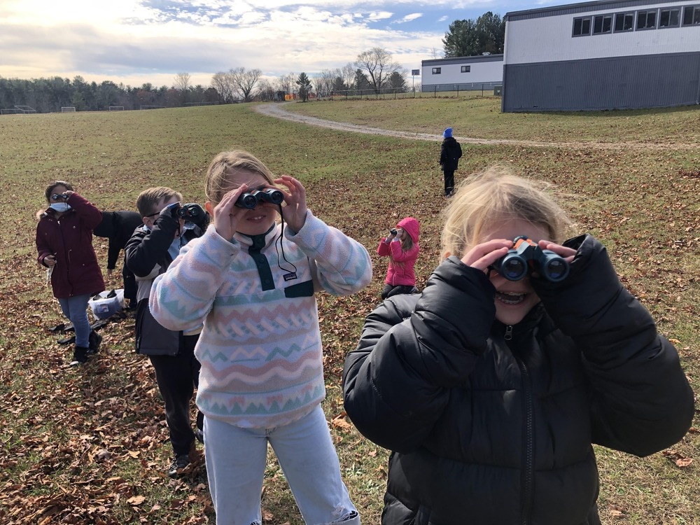 students with binoculars