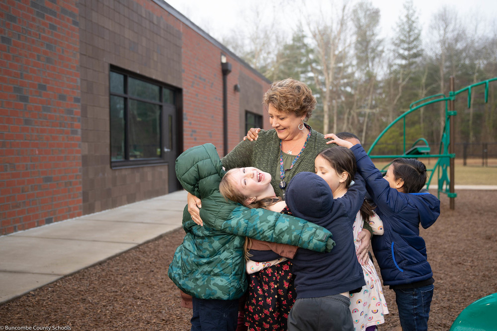 Ms. Kertesz with a group of students on one of the playgrounds. 