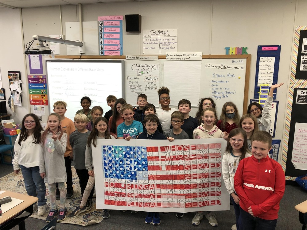 students with United States flag poster