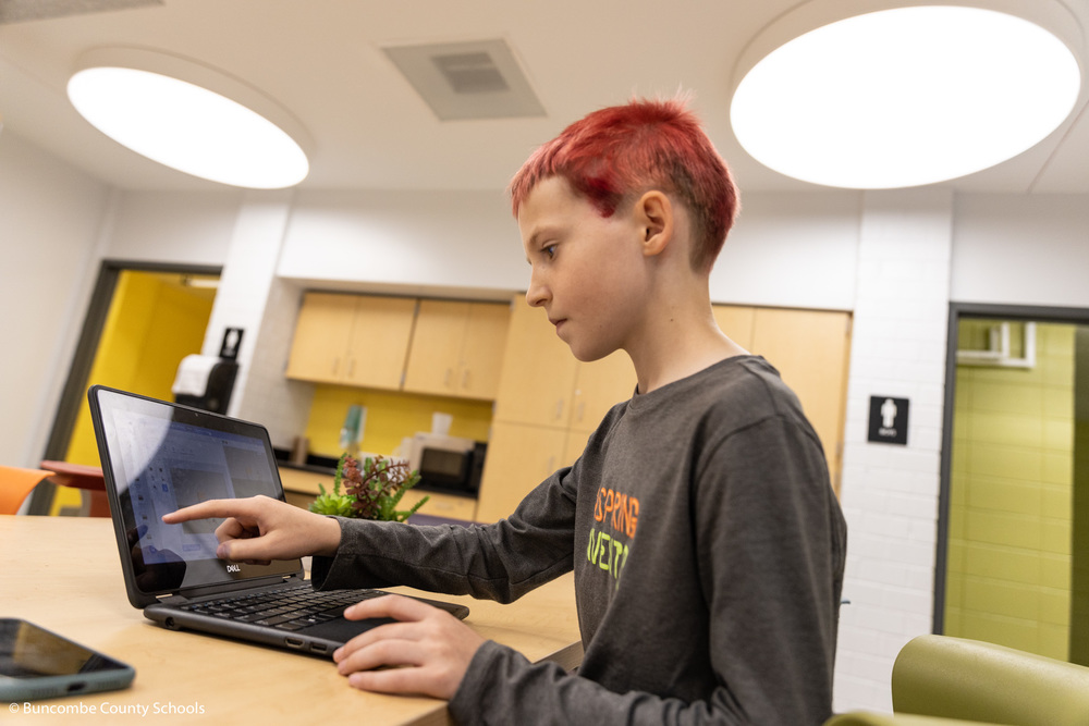 Finn showing the game he coded.