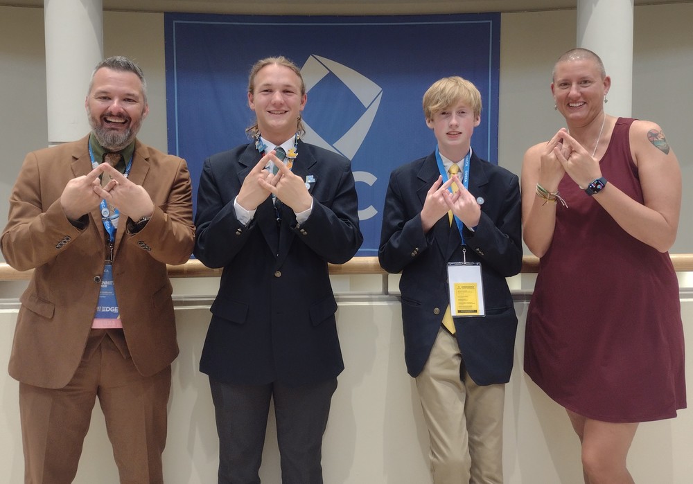 photo of students and teachers posing at DECA conference