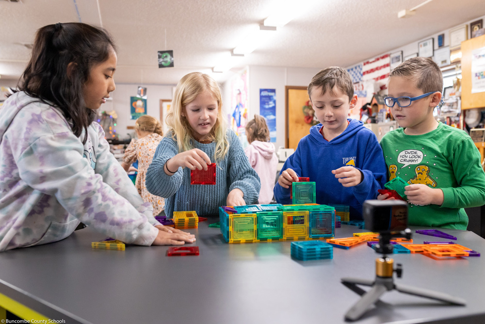 Students work with Connetix magnetic building tiles.