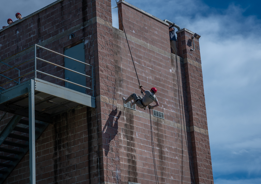 JROTC student repelling down fire tower.