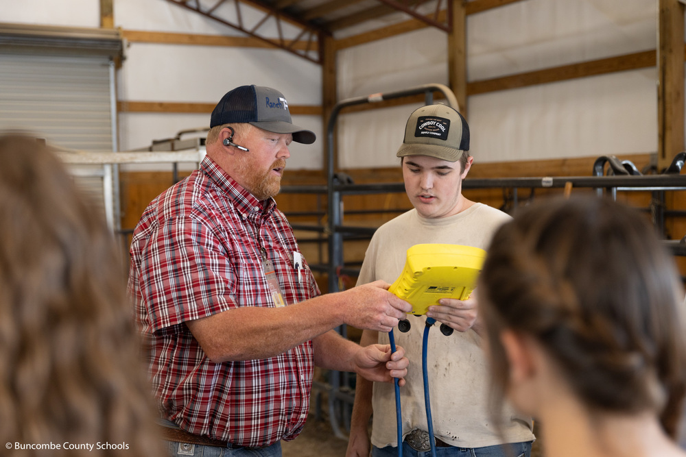 Mr. Gillespie working with a student in the school's barn.