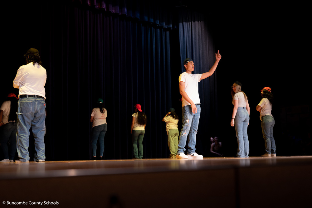 Students doing a group dance at the spring showcase.