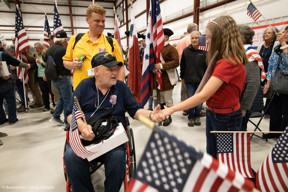 Student welcoming home a veteran from the Blue Ridge Honor Flight