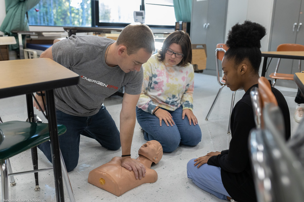 CPR being taught with CPR dummy
