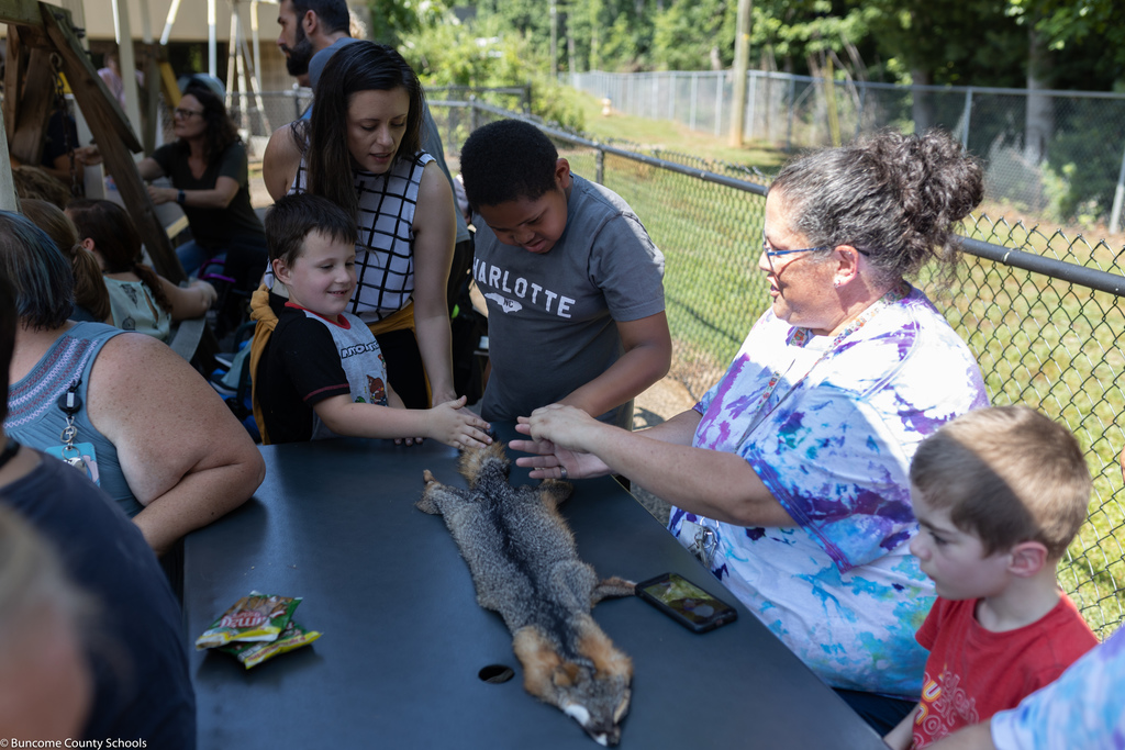 Students rubbing fox fur from Blue Ridge Parkway Ranger