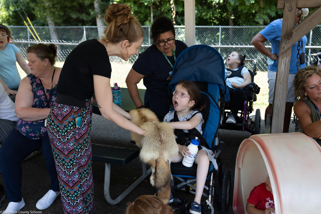 Students rubbing fox fur from Blue Ridge Parkway Ranger
