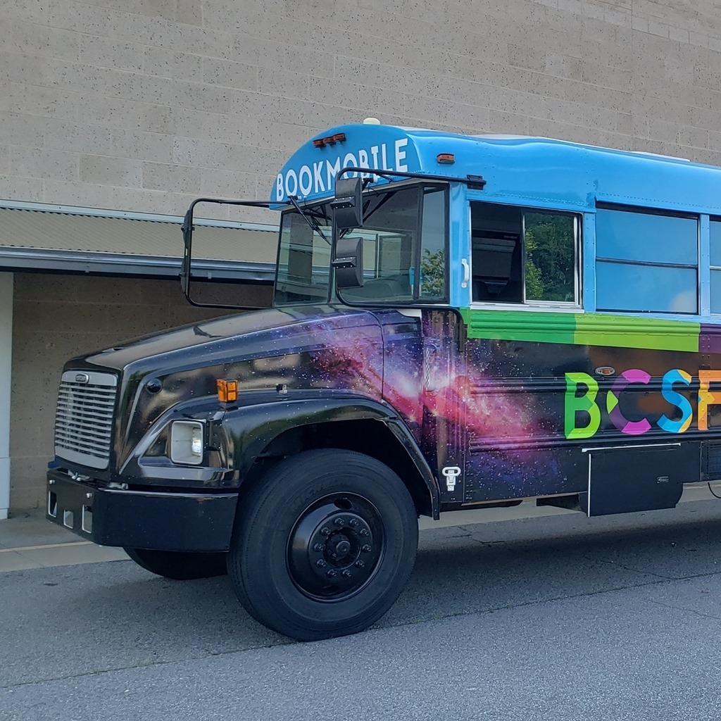 school bus painted in fun colors with words "Book Mobile" painted on it