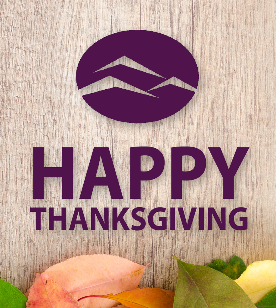 Happy Thanksgiving with wood and leaves in the background.