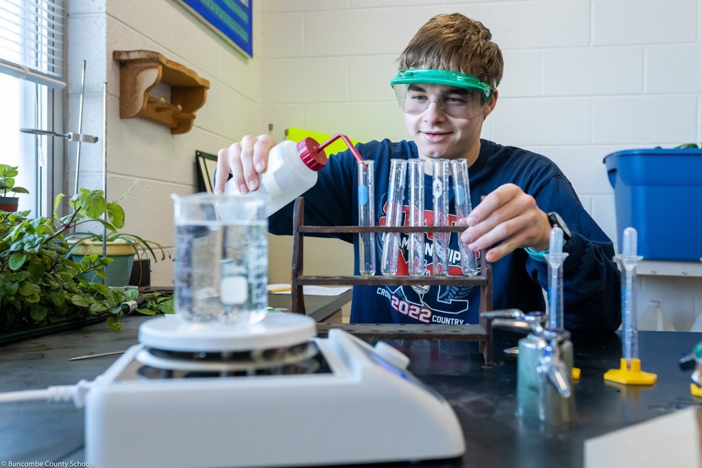 Student pouring liquid in lab