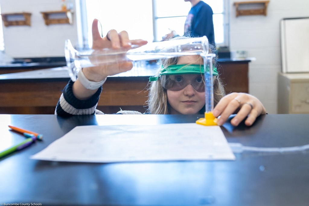 Student pouring liquid in lab