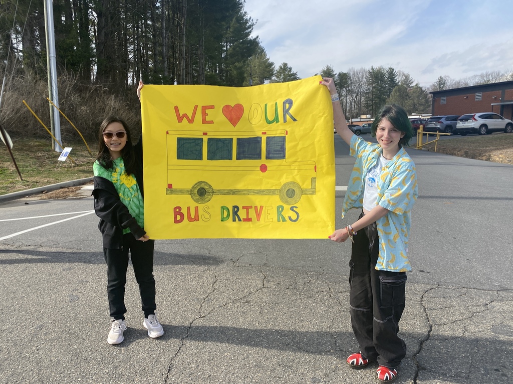 Students holding a "We Heart Our Bus Drivers" sign