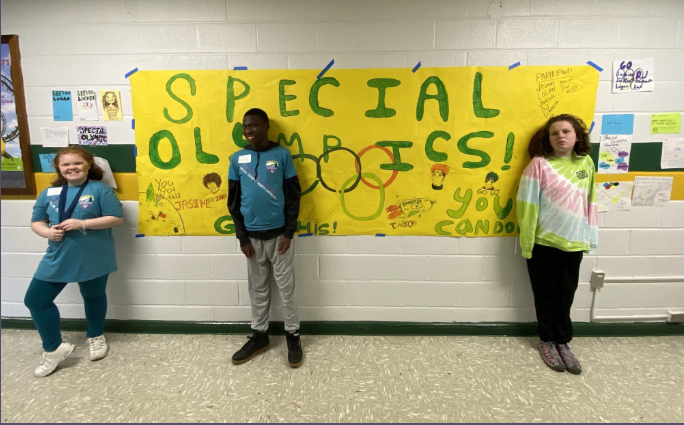 Students in front of Special Olympics sign