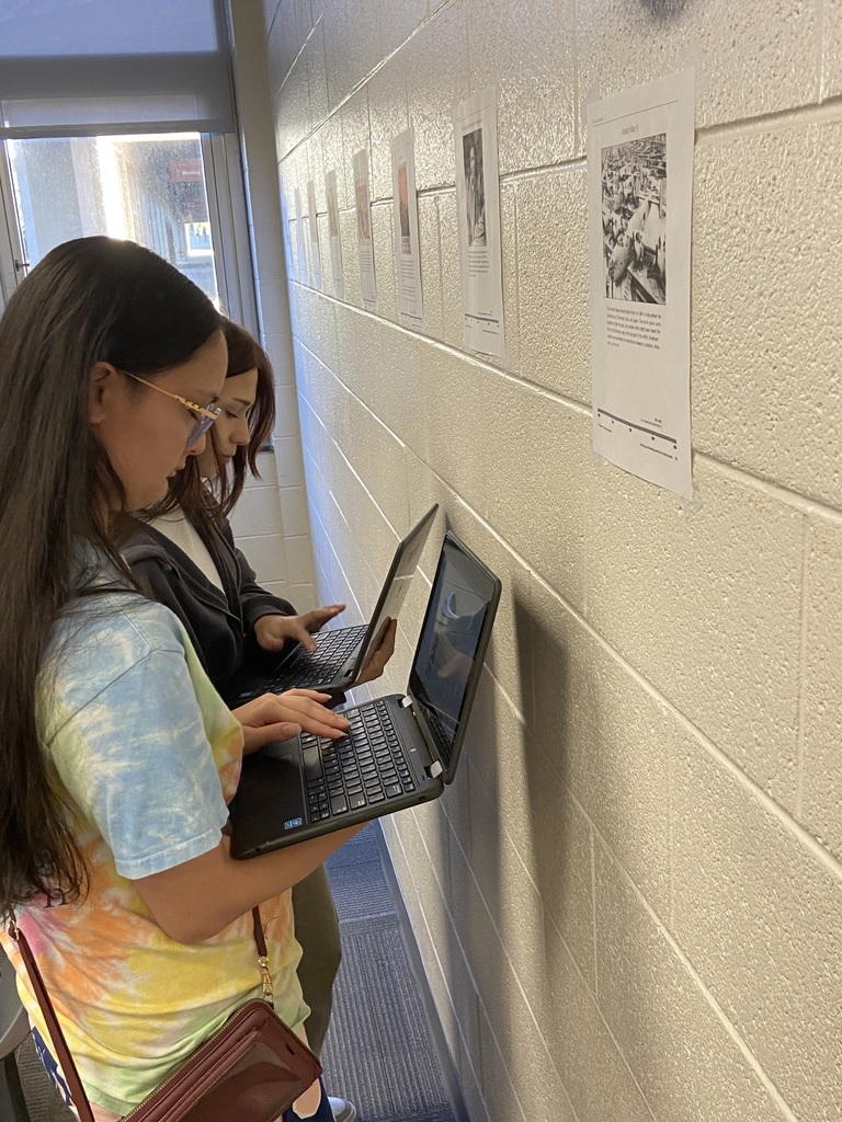 Students standing with computers