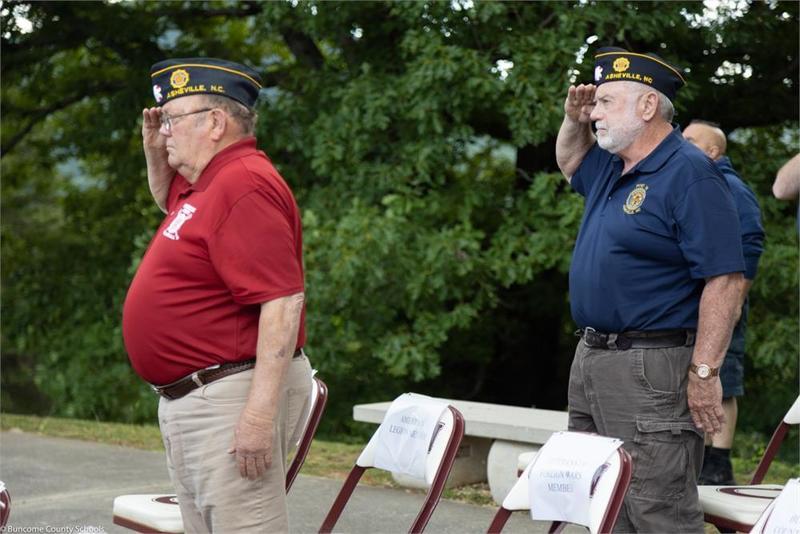 Two veterans saluting