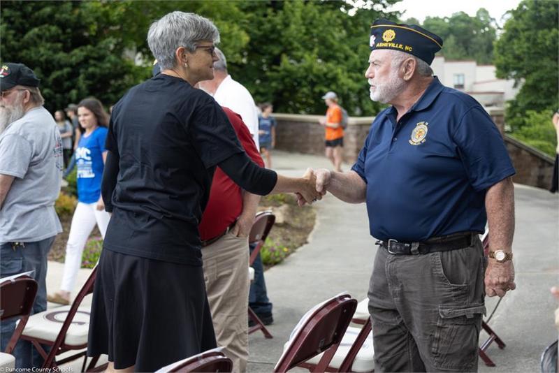 A veteran and a civilian shaking hands