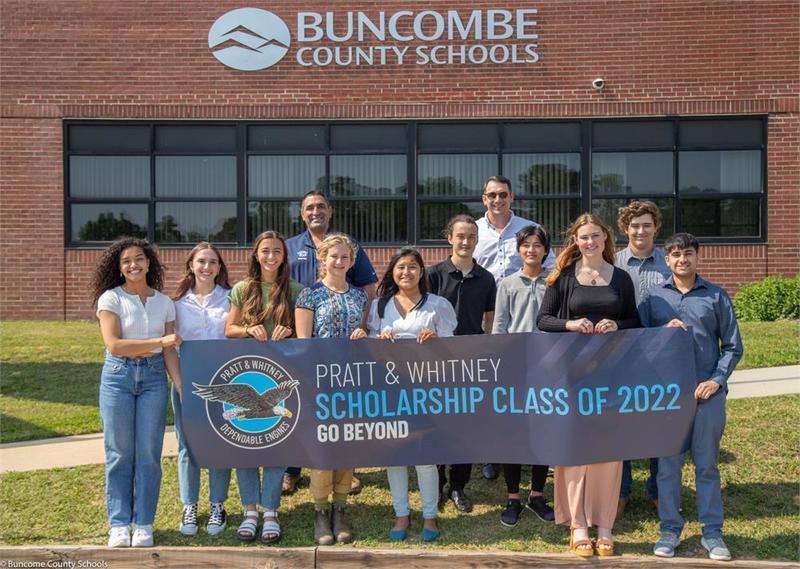 A group of students holding a banner that says Pratt & Whitney Scholarship class of 2022. Go beyond
