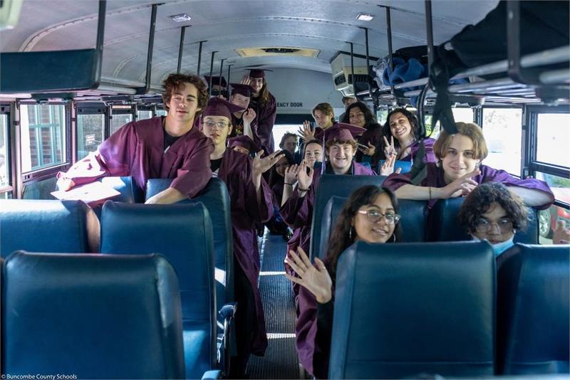 Graduates in a school bus