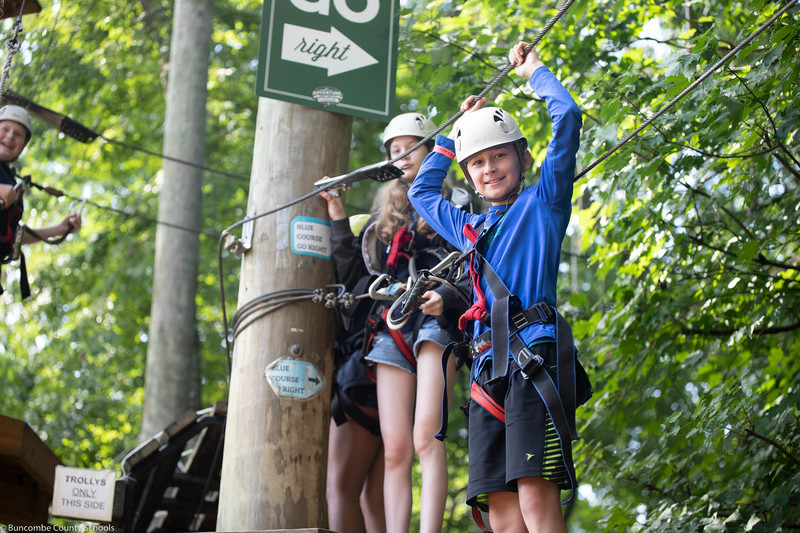 Students climbing the ropes course