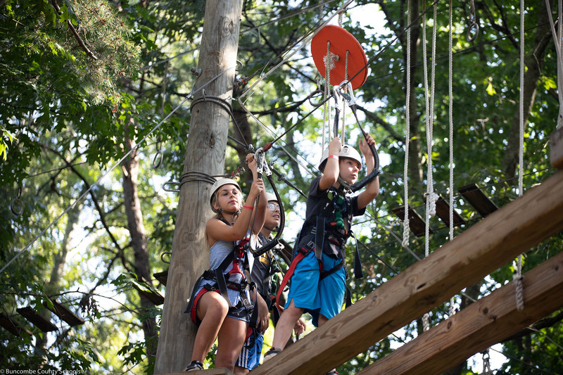 Students climbing the ropes course.