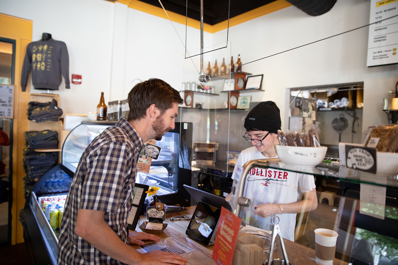 Juan helping a customer at High Five Coffee