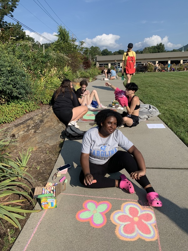 Student creating artwork at the Chalk the Walk event.