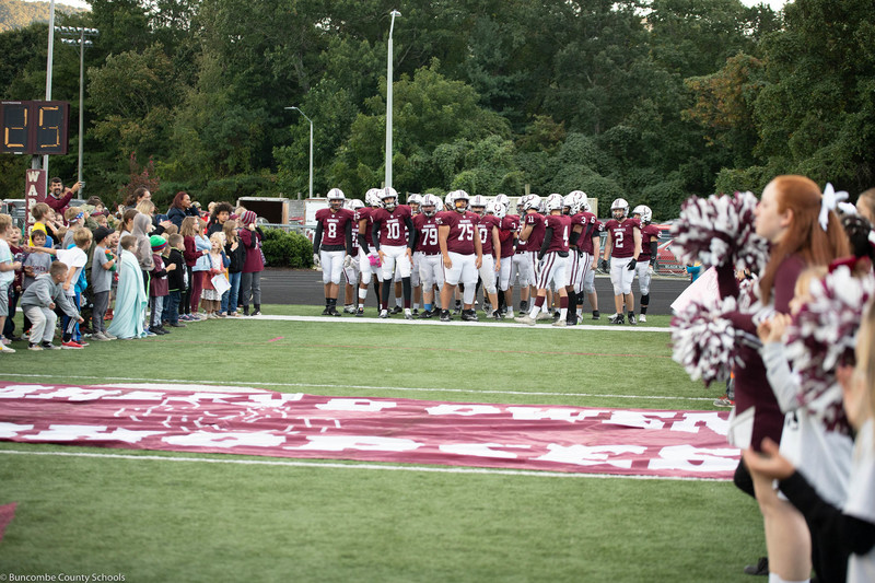 Owen football team preparing to run out on the field.