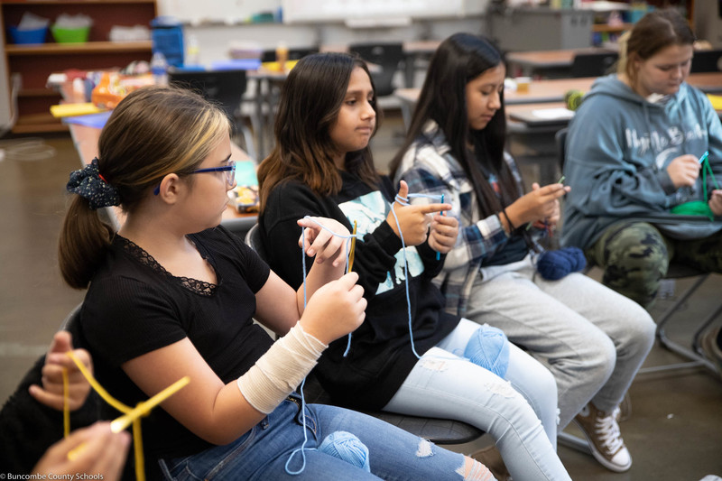 Students learning to crochet. 