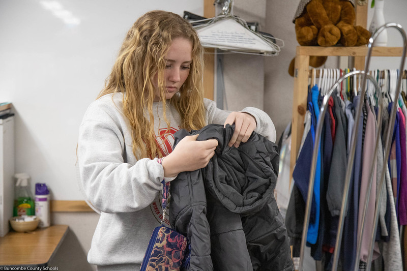 Student sorting clothes at the Family Resource Center. 