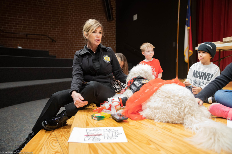Students visiting with the Buncombe County Sheriff Department's therapy dog Deputy Kora