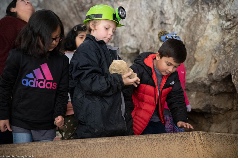 Student holding a rock in the Bon Ami mine. 