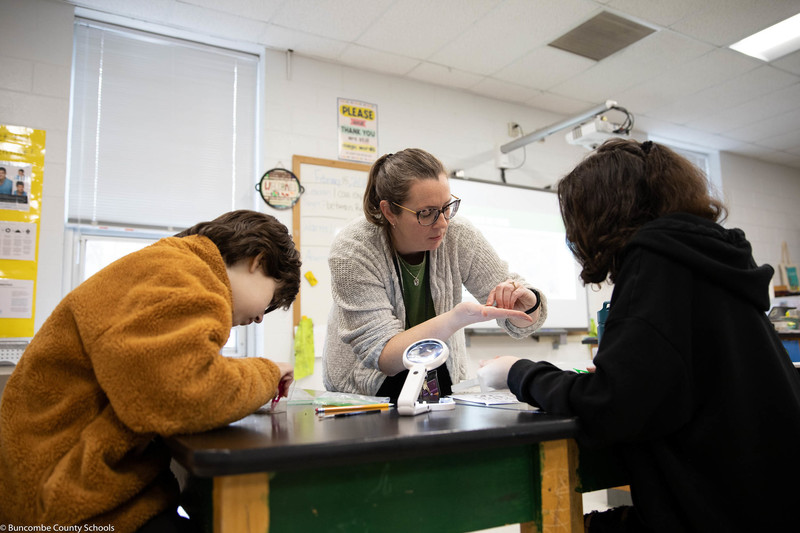 Ms. Hamilton helping student with the lab process. 