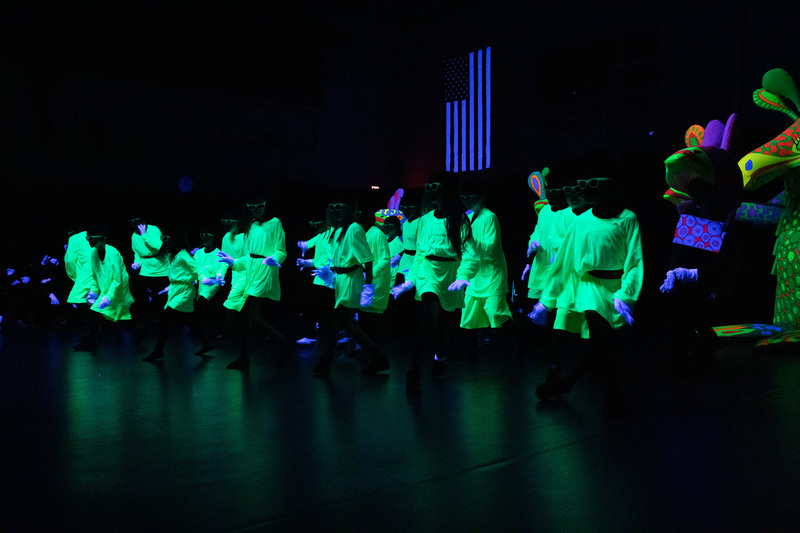 Students performing a routine for the black light show. 