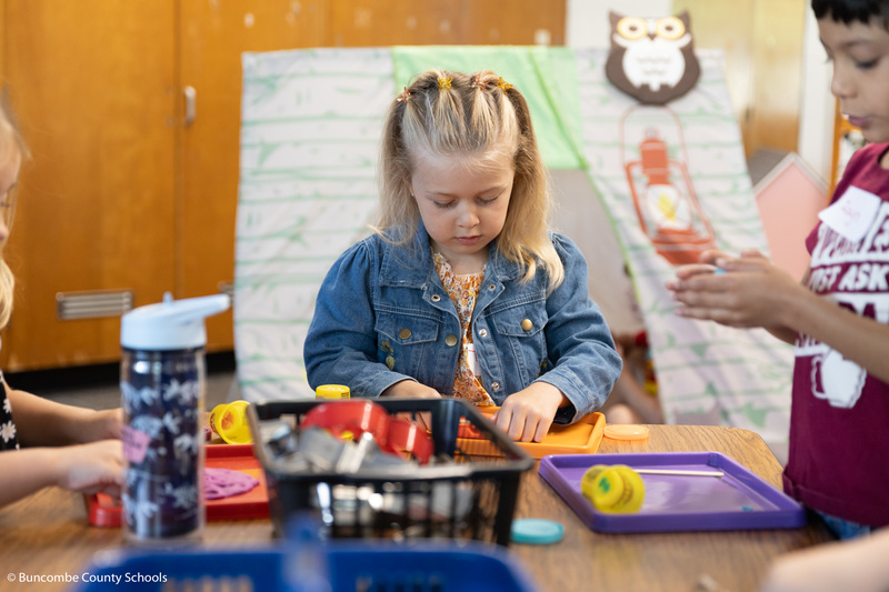 Student playing with Play-Doh.