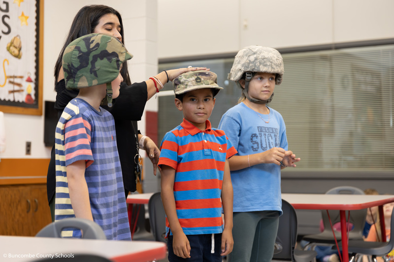 Students trying on Ms. Padilla's military attire. 